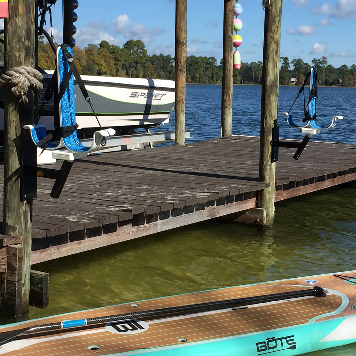 Installed mounts with S1 racks in the dock and a paddleboard in the water.