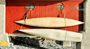 Image of kayaks on a beach, with a Manta Racks logo in the corner.