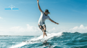 Image of a man wakeboarding in the water, balancing on a wave.